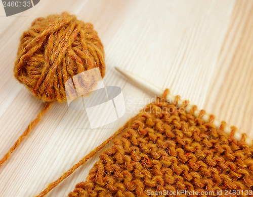 Image of Closeup of garter stitch knitting and orange wool