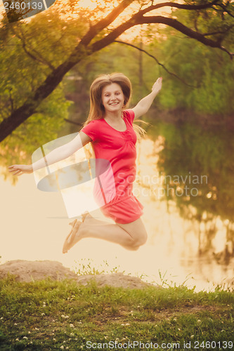 Image of Happy Young Girl Jumping On The Park