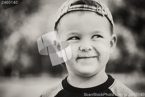 Image of Happy child wearing striped cap in outdoor portrait