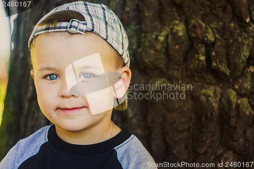 Image of Happy child wearing striped cap in outdoor portrait