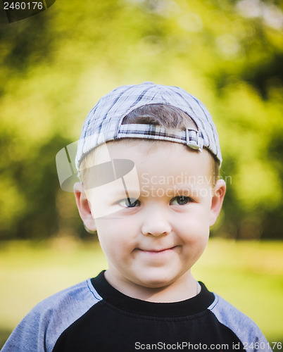 Image of Happy child wearing striped cap in outdoor portrait