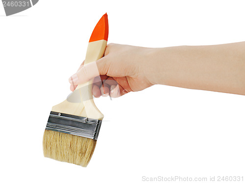 Image of Female hand holding paint brush isolated on white background.