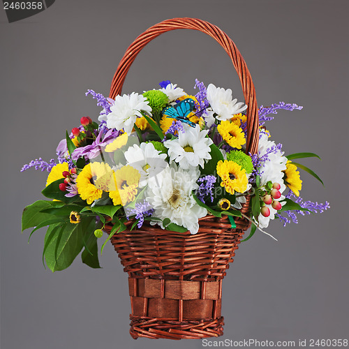 Image of Colorful flower bouquet arrangement centerpiece in wicker basket