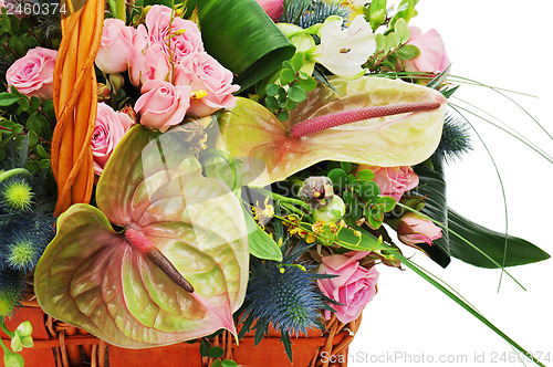 Image of Fragment of flower bouquet in wicker basket isolated on white ba