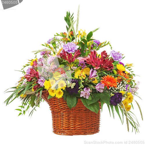 Image of Flower bouquet arrangement centerpiece in wicker basket isolated