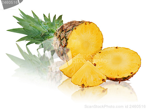 Image of Ripe pineapple with slices isolated on white background.