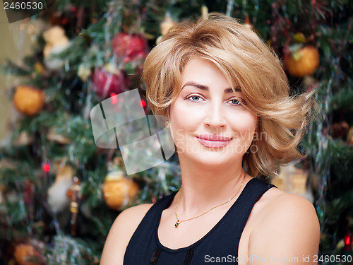 Image of Portrait of young woman on holidays background.