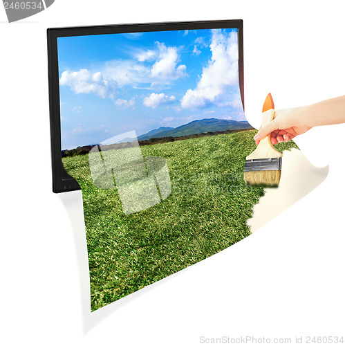 Image of Conceptual idea: monitor, hand and brush. 