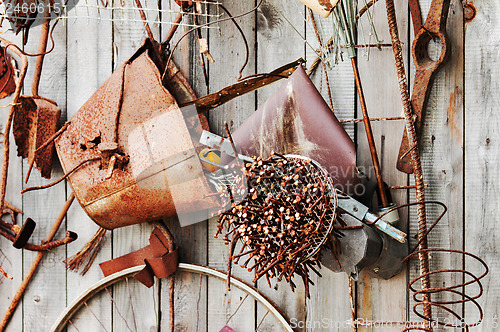 Image of Still-life of rusty metal items on wooden background.