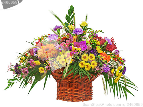 Image of Flower bouquet arrangement centerpiece in wicker basket isolated