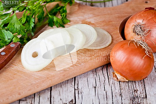 Image of fresh onions, knife and parsley 