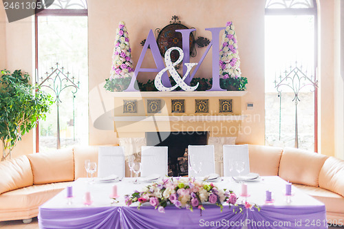 Image of Bride and groom's table decorated with flowers