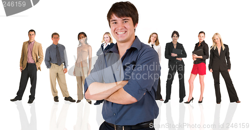 Image of Young businessman standing in front of a business people group