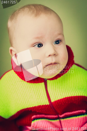 Image of Portrait Of Sad Baby Boy On Green Background