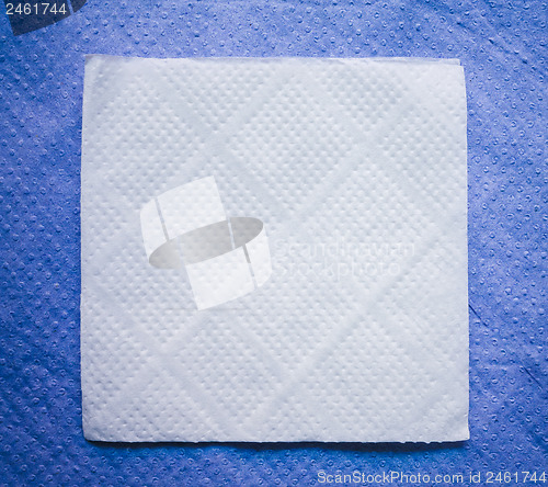 Image of Paper Napkin On Blue Napkin Background