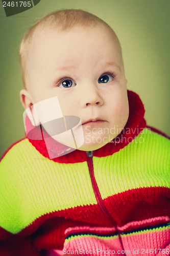 Image of Portrait Of Sad Baby Boy On Green Background