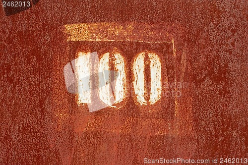 Image of Number 100 painted on an old rusty surface