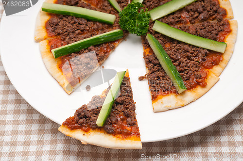 Image of Turkish beef pizza with cucumber on top