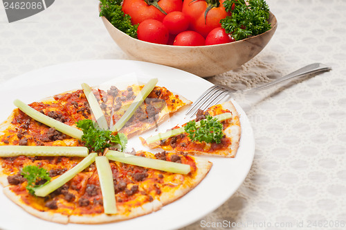 Image of Turkish beef pizza with cucumber on top