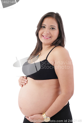 Image of hispanic pregnant woman smiling and touching her belly