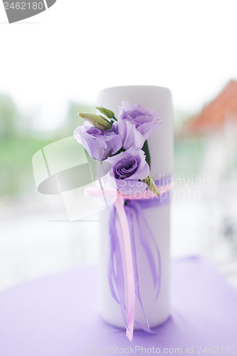 Image of candle decorated with flowers