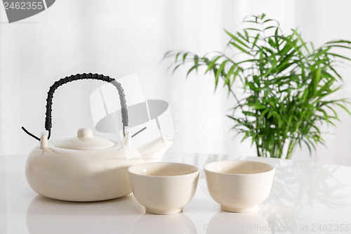 Image of Ceramic teapot and cups on the table