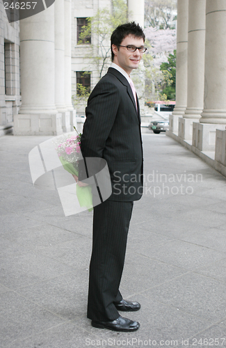 Image of Young man with flowers