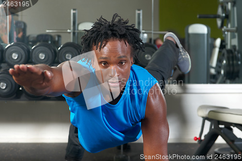Image of Man exercising in gym