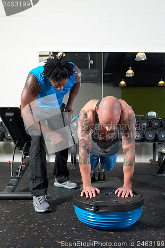 Image of Man with trainer in gym