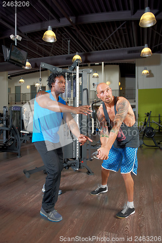 Image of Man with trainer in gym