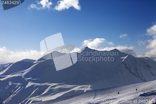 Image of View on ski slope and beautiful mountains in evening