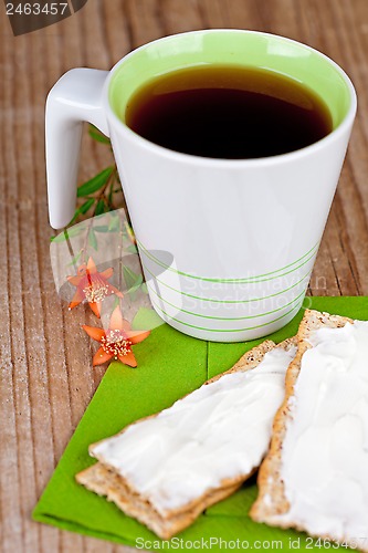 Image of cup of tea and crackers with cream 