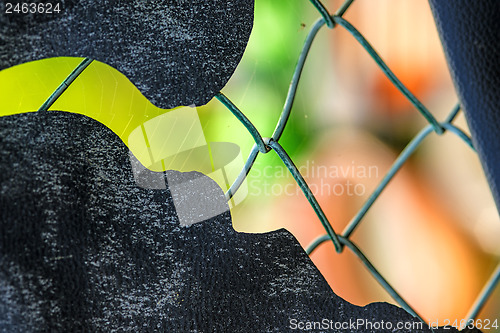 Image of fence with colorful background