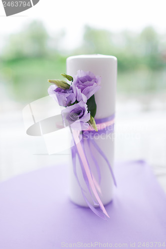 Image of candle decorated with flowers