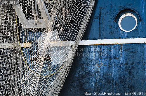 Image of Window of the ship and hanging down networks, close up