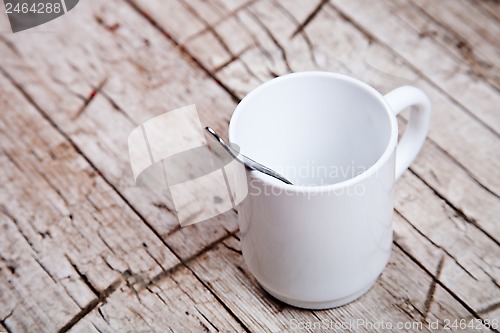 Image of empty white cup and spoon 