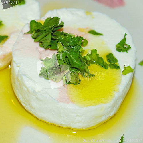 Image of Tomino cheese with rucola and olive oil