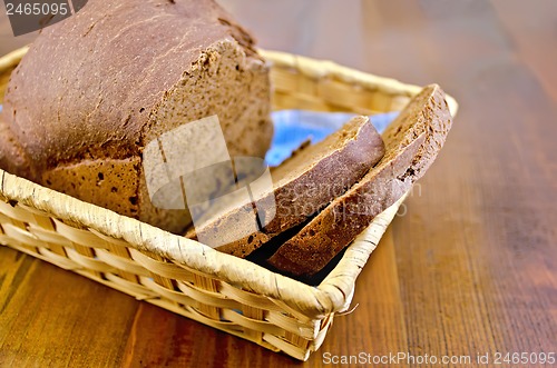 Image of Rye homemade bread in a wicker basket on the board