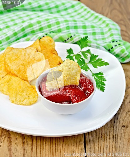 Image of Chips with tomato sauce on the board