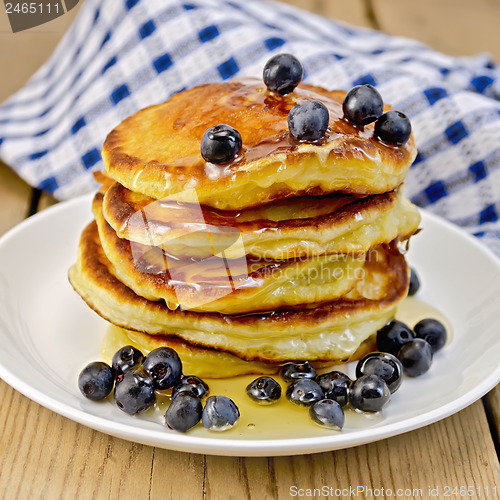 Image of Flapjacks with blueberries and honey on the board