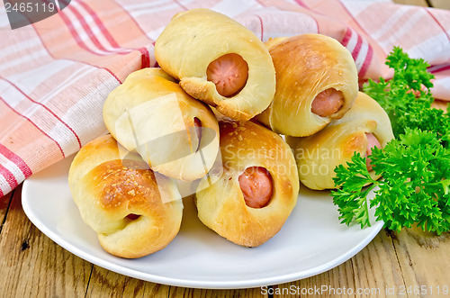 Image of Sausage rolls on a plate with parsley