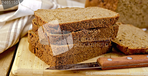 Image of Rye homemade bread stacked with a knife on a board