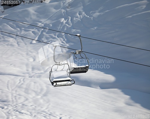 Image of Two chair-lift with snowdrift in sun morning