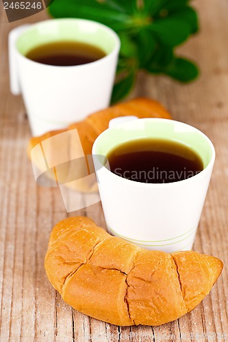 Image of two cups of tea and fresh croissants 