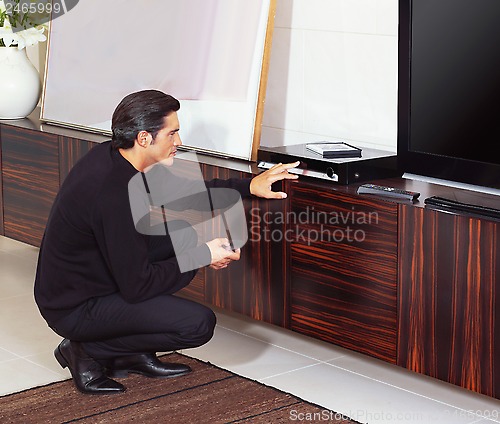 Image of man using dvd player