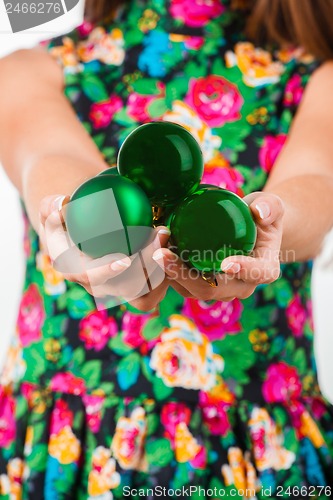 Image of Young woman hands with christmas ball