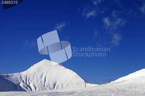 Image of Ski slope with ropeway at sunny winter day