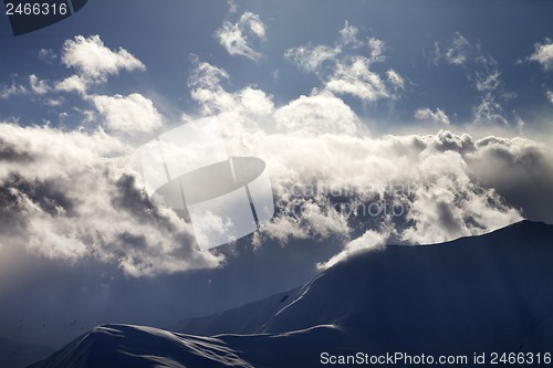 Image of Evening mountain in haze and sunlight clouds