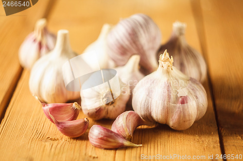 Image of Raw garlic on wooden background