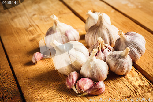 Image of Raw garlic on wooden background
